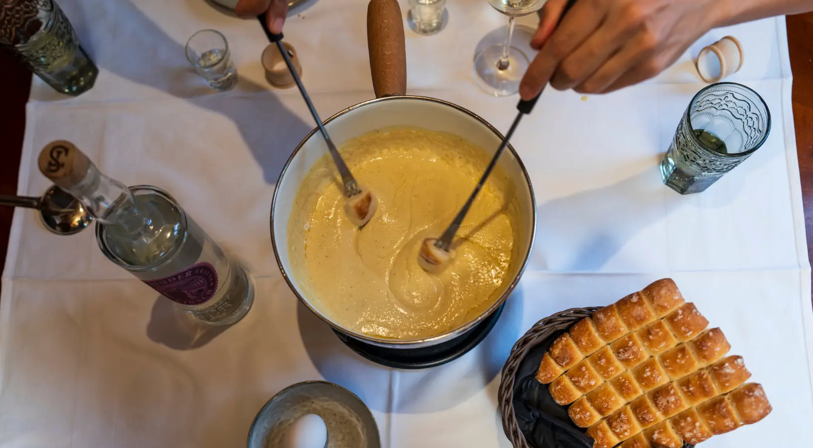 Traditional Swiss cheese fondue served at a cozy table, a must-try culinary experience among the hidden gems in Lucerne.