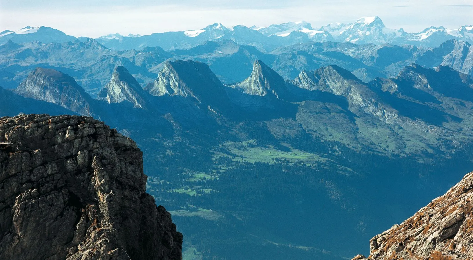 Traditional Swiss alpine village with snow-capped mountains highlighted in Switzerland Tour Packages