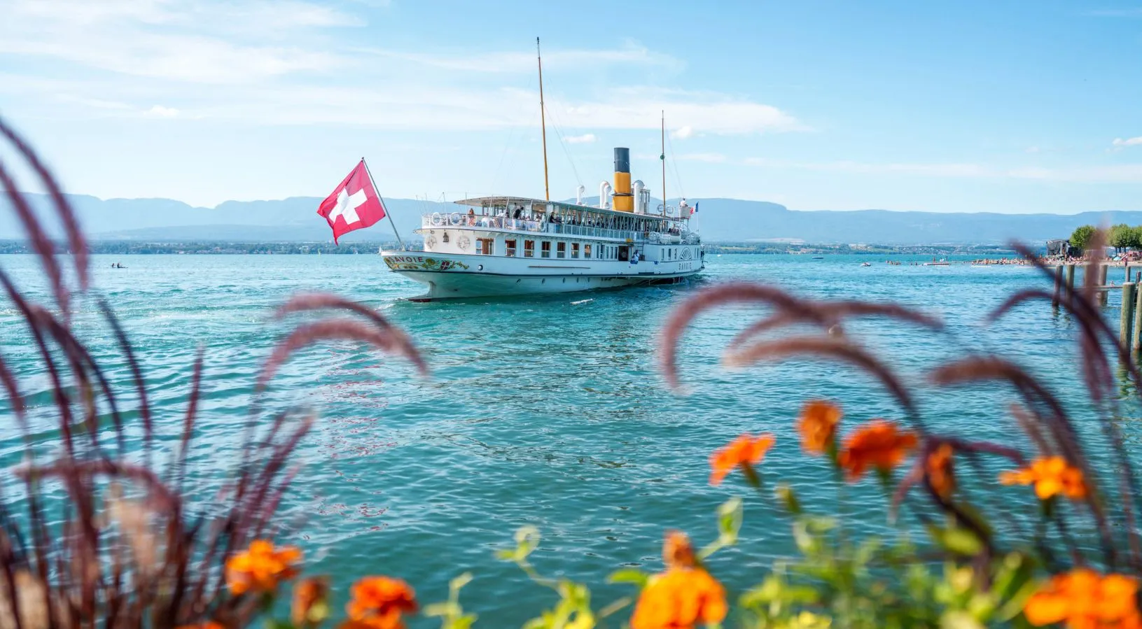 Swiss lake cruise with historic boat and national flag, included in Swiss Travel Pass 3, 4 or 8 days
