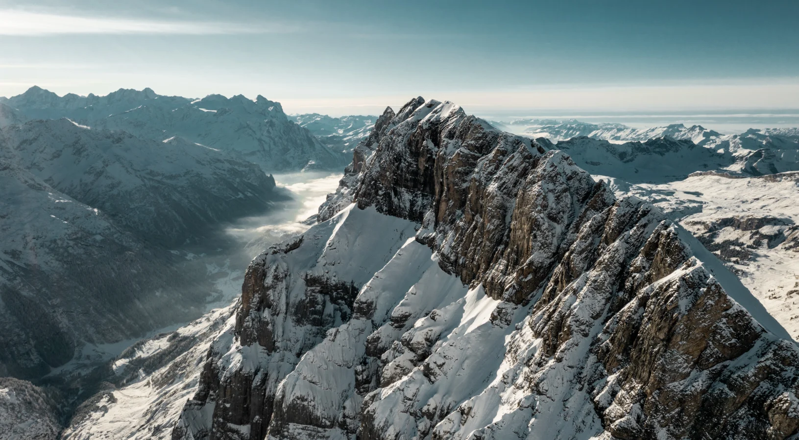 The snow-covered rocky summit ridge of Mount Titlis above Engelberg, illustrating the mountain discounts included with the Swiss Travel Pass